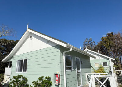 Exterior of the King Studio Cottage at Ash Grove Motel in Paihia, with private entrance and surrounding garden.